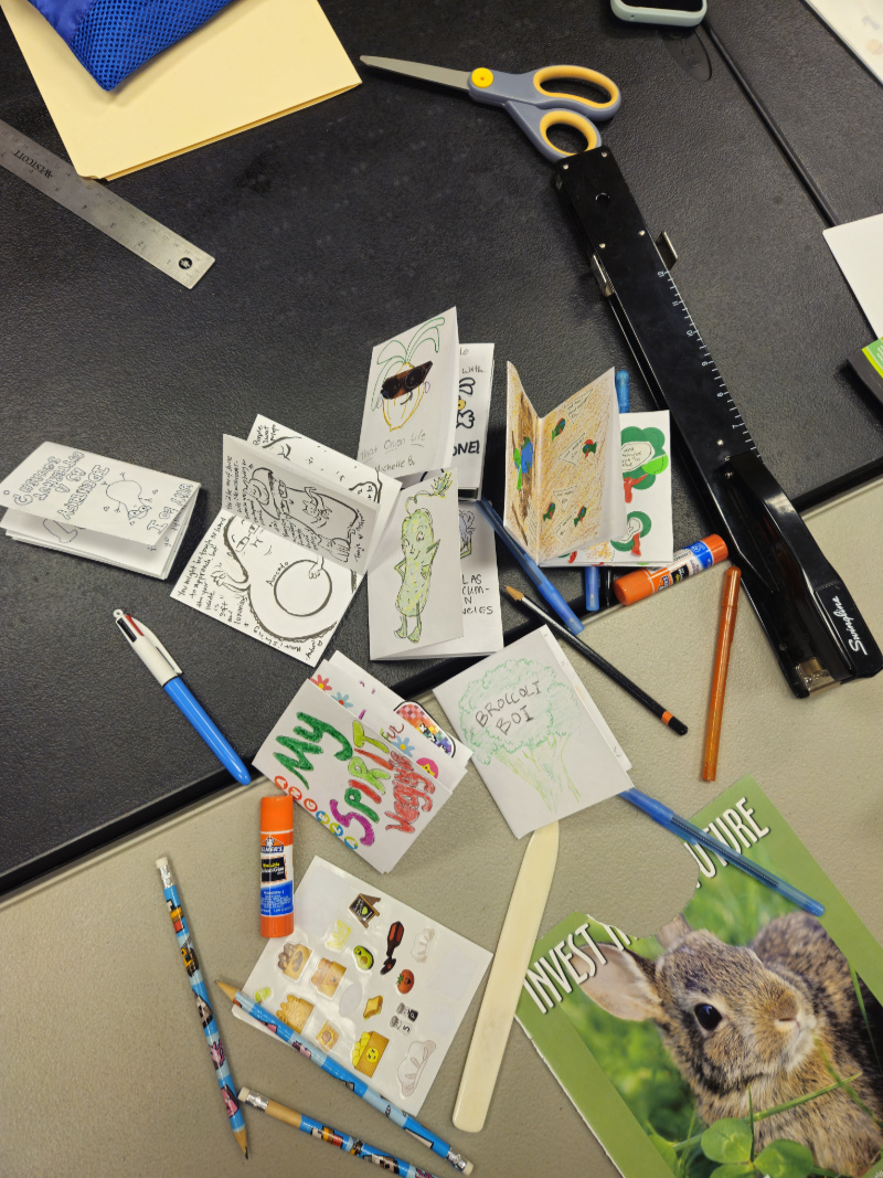 top down image of hand made zines on the theme of veggies